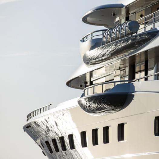 A side view of a luxury yacht exposed to the sun.